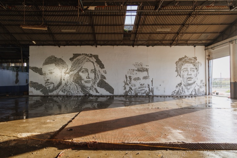 Netflix x Vhils - carved portrait mural revealed by controlled explosion, Setubal warehouse